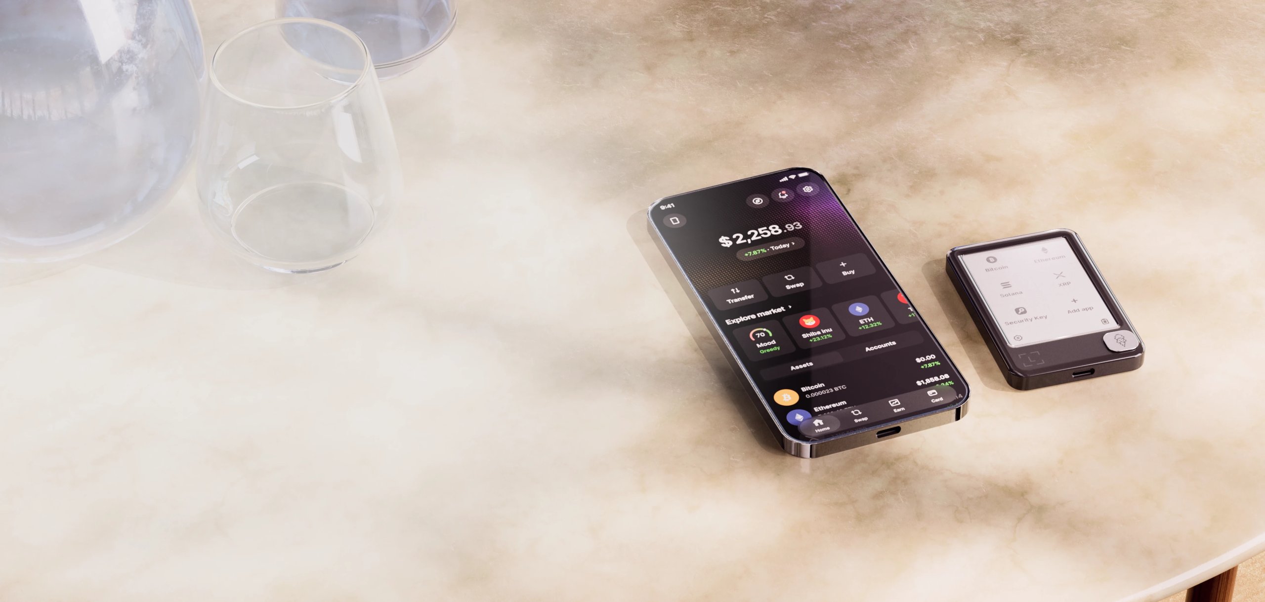 Two smartphones displaying cryptocurrency finance apps lie diagonally on a pale tabletop.